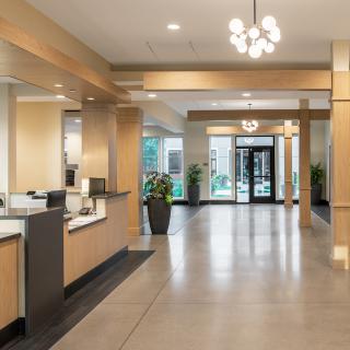 A modern hotel lobby with a sleek reception area and contemporary lighting.