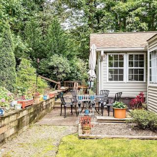 A cozy garden patio with outdoor seating and lush greenery.