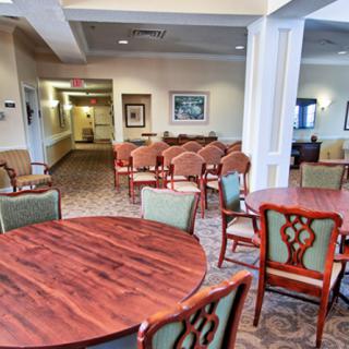 A cozy lounge area with multiple seating arrangements and wooden tables.