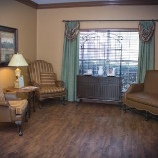 A cozy living room featuring comfortable chairs and natural light from the window.