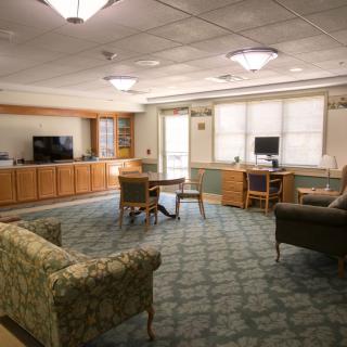 A cozy lounge area with comfortable seating and a television.