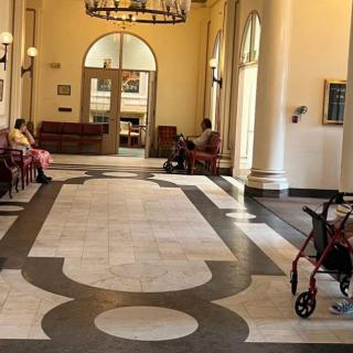 A well-lit waiting area with seating and a wheelchair in the foreground.