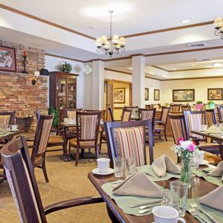 A well-decorated dining room with neatly arranged tables and chairs, ready for guests.