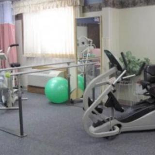 A rehabilitation room equipped with exercise machines and therapy tools.