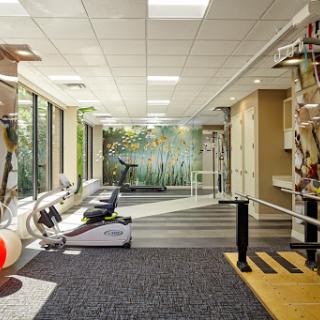 A modern fitness center equipped with various exercise machines and a serene ambiance.