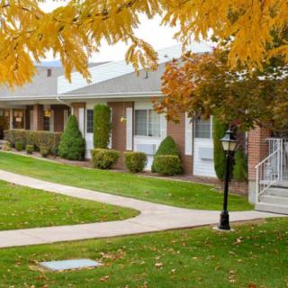 A scenic view of a residential area in autumn with colorful leaves and well-maintained pathways.