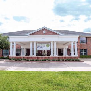 A school building with a prominent entrance featuring columns.