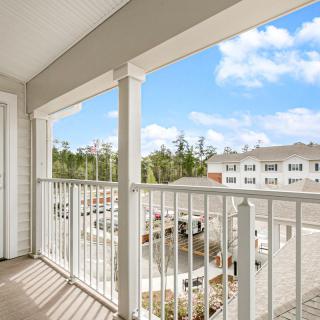 A scenic view from an apartment balcony overlooking a residential area.