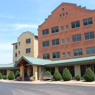 A hotel building with a prominent entrance and landscaped surroundings.