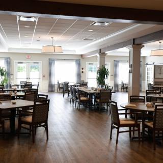 An elegant dining room interior with neatly arranged tables and chairs.