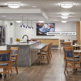 A modern kitchen and dining area with stylish lighting and furnishings.