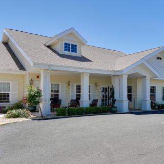 A single-story residential building with a large porch and columns.