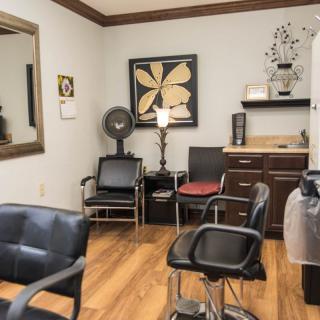 A cozy hair salon with stylish interiors and comfortable seating.