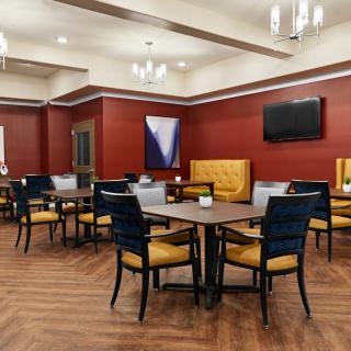 A modern dining area with stylish furniture and warm lighting.
