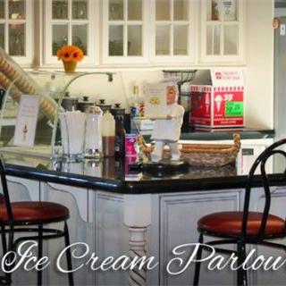 A cozy ice cream parlor setup with a kitchen counter and bar stools.