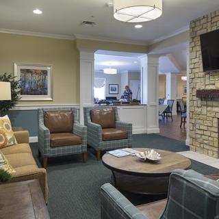A cozy living room featuring comfortable seating, a coffee table, and a television.