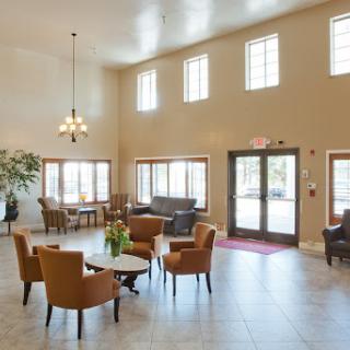 A spacious and inviting lobby featuring comfortable seating, large windows for natural light, and a modern design.