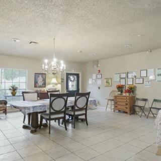 A spacious dining room with elegant furniture and decorative elements.