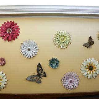 A vibrant display of decorative flowers and butterflies adorning a wall.