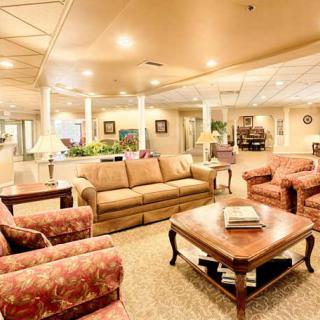 Elegant and spacious living room with comfortable seating and warm lighting.