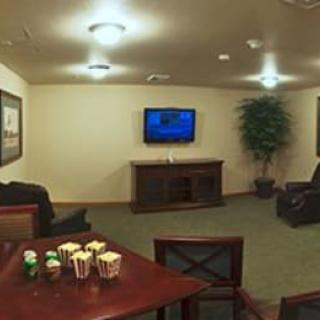 A cozy living room with a television and comfortable seating arrangement.