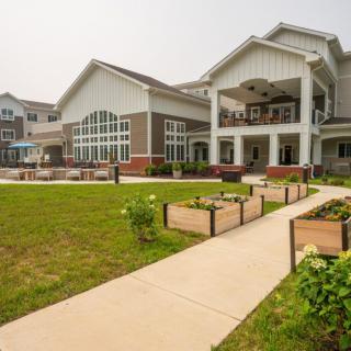 A modern building with a landscaped garden and pathway.