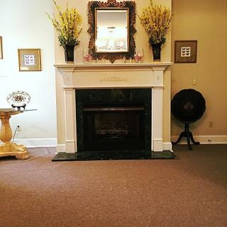 A cozy living room with a classic fireplace and decorative elements.