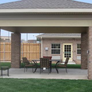 A cozy outdoor patio area with a gazebo, table, and chairs, perfect for relaxing in the backyard.