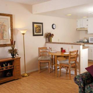 Cozy living space with a small dining area and adjacent kitchen.