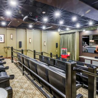 Spacious home theater with comfortable seating and ambient lighting.