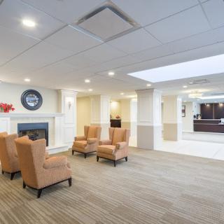 A modern lobby with comfortable seating and a fireplace.