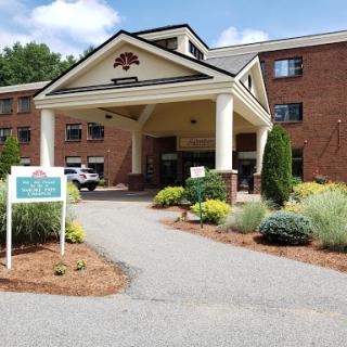A welcoming hotel entrance with well-maintained landscaping.