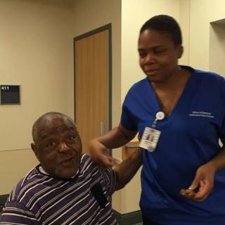 A nurse assists an elderly man in a healthcare setting.