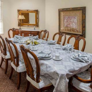 A beautifully set dining table with elegant chairs and tasteful decor.