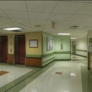 A quiet hospital corridor with clean, polished floors and soft lighting.