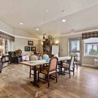 A spacious dining room with elegant furniture and warm decor.