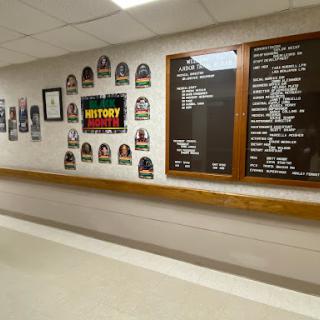 A hallway featuring historical displays and information boards.