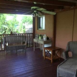 A cozy outdoor patio area with seating and garden views.