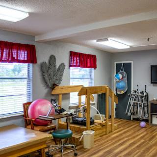 A bright and inviting rehabilitation area equipped with various exercise tools for physical therapy.