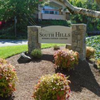 Entrance sign for South Hills Residential Community, surrounded by greenery.