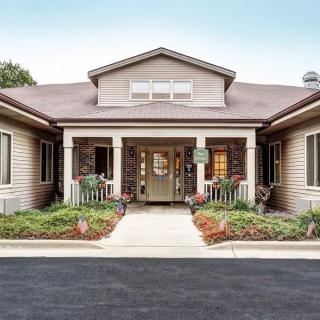 A symmetrical residential building with well-maintained landscaping at the entrance.