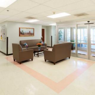 A spacious and comfortable waiting area with sofas and a table.