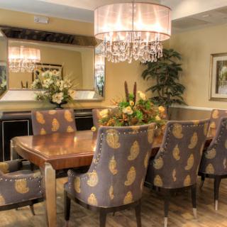 A beautifully designed dining room featuring stylish chairs, a wooden table, and an elegant chandelier.
