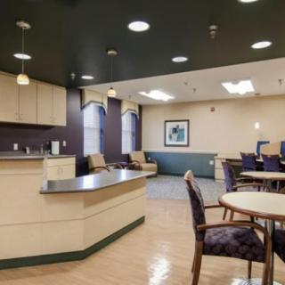 A communal seating area with tables and chairs, featuring modern lighting and decor.