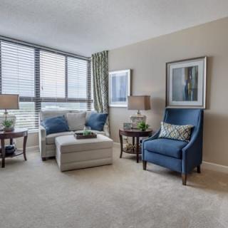 A modern living room with stylish furniture and large windows.