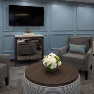 Modern living room with elegant furniture and a wall-mounted television.