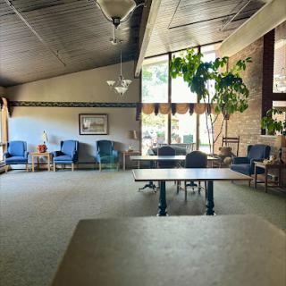 A spacious lounge area featuring comfortable seating and abundant natural light.