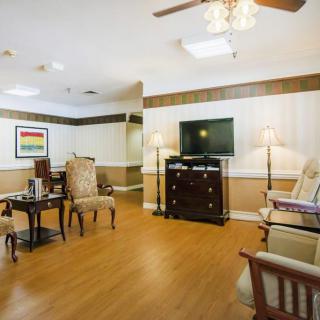 A cozy living room with elegant furniture and a television.