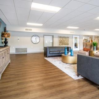 A modern living room with wooden flooring, stylish furniture, and elegant decor.