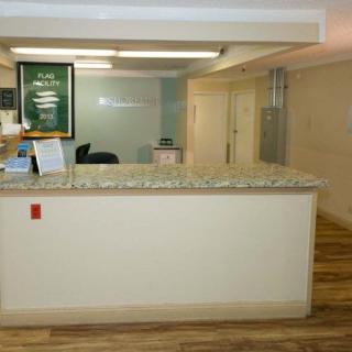 A reception desk area in an office with a granite countertop and decorative elements.